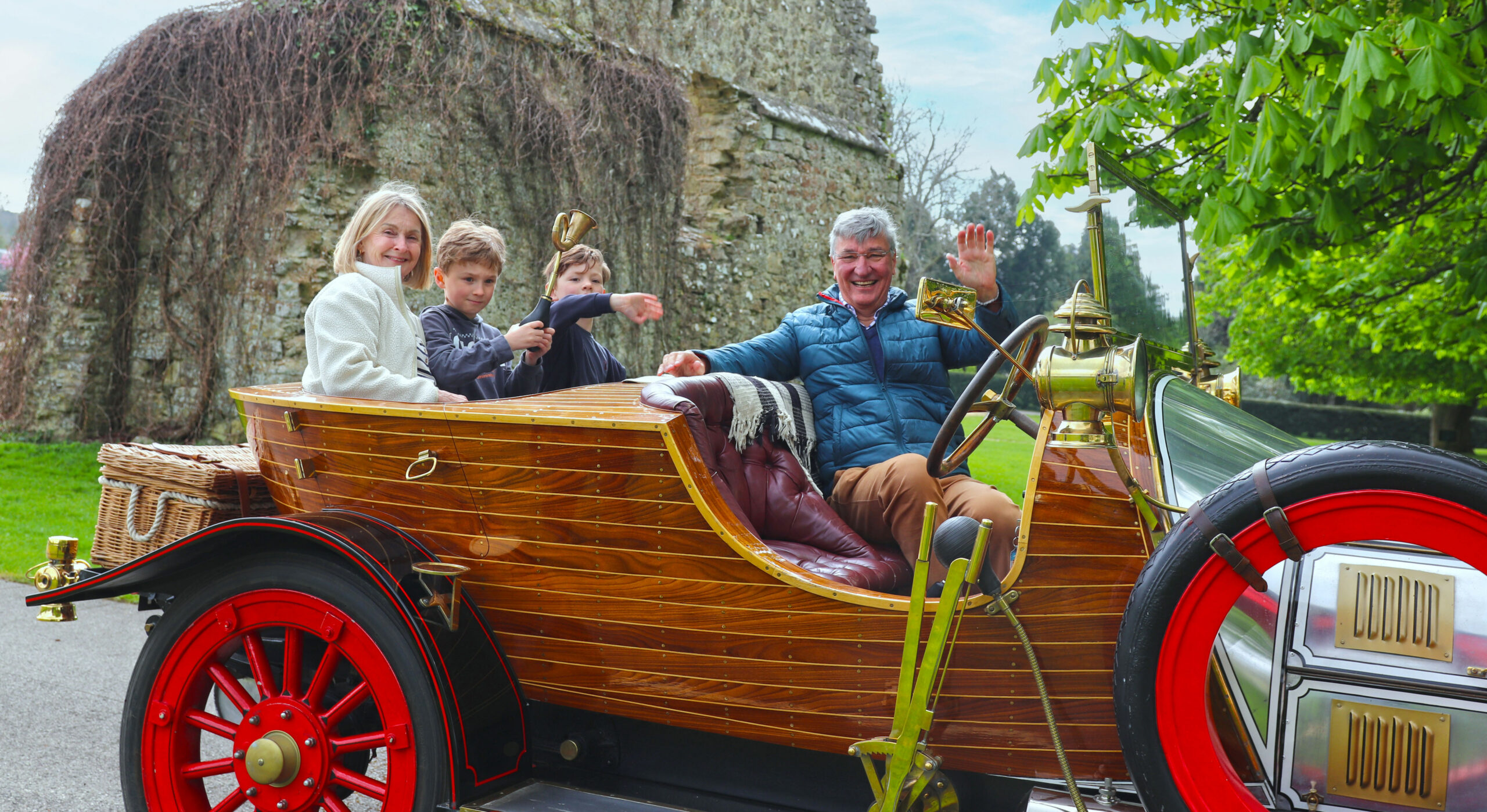 Family enjoying rides in Chitty Chitty Bang Bang during May half-term at Beaulieu