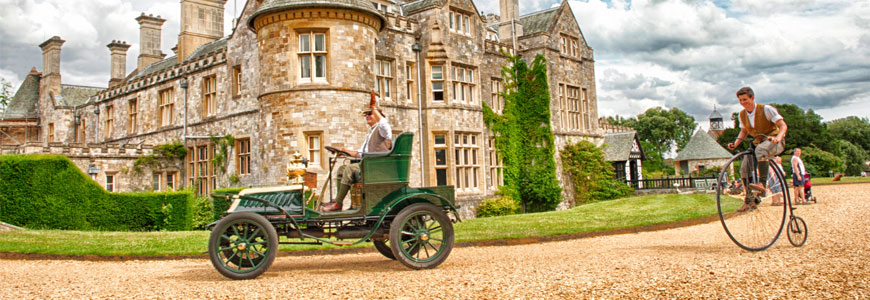 Living History characters drive past Palace House