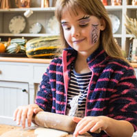 A visitor rolls out dough for soul cakes in Palace House