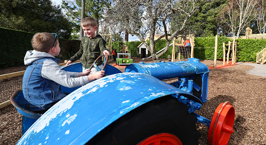 Two children playing on the tractor in Little Beaulieu