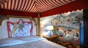 Big-top-canopy-above-bed-with-clowns-and-jugglers-on-folding-screen