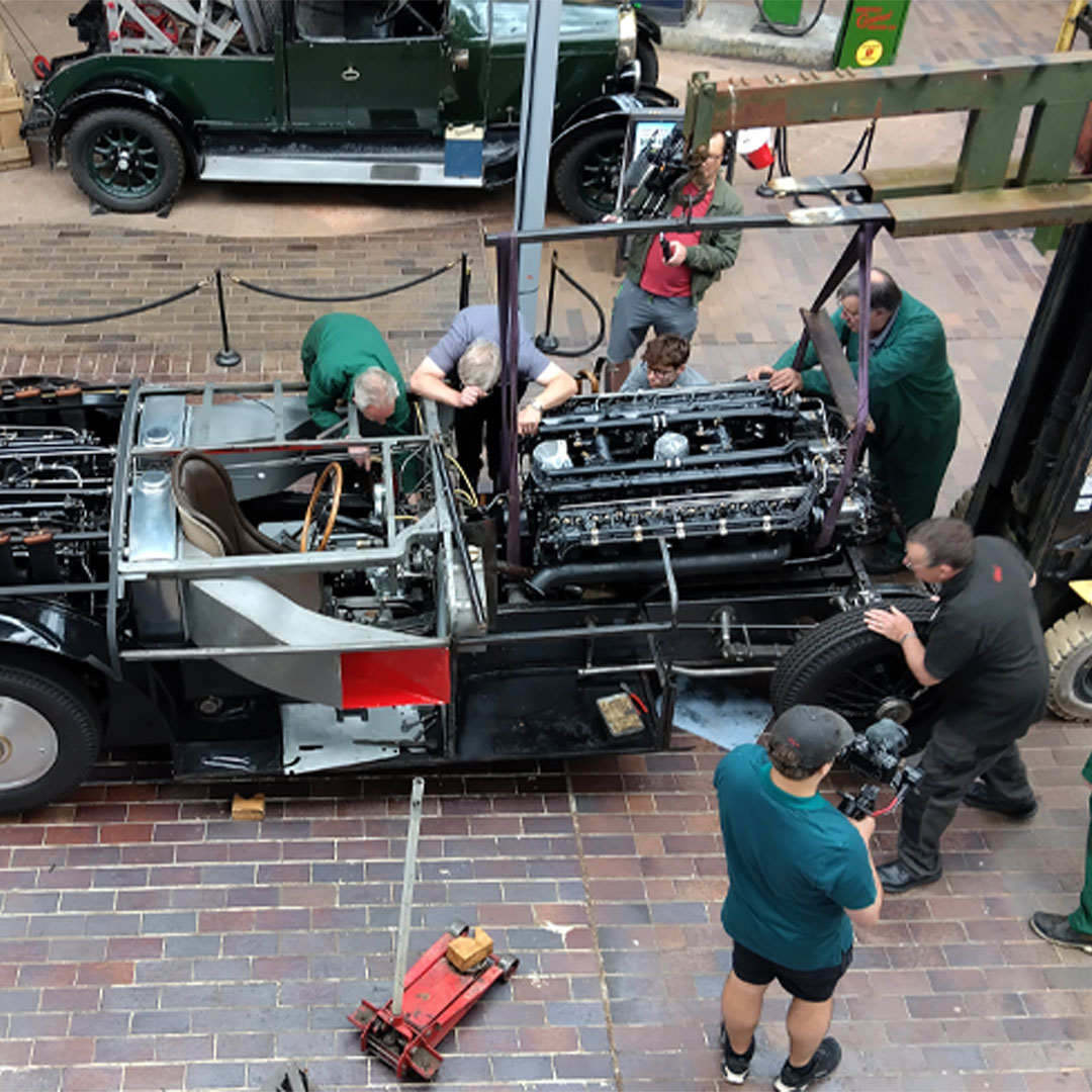Lowering restored second engine into Sunbeam 1000hp chassis in the National Motor Museum