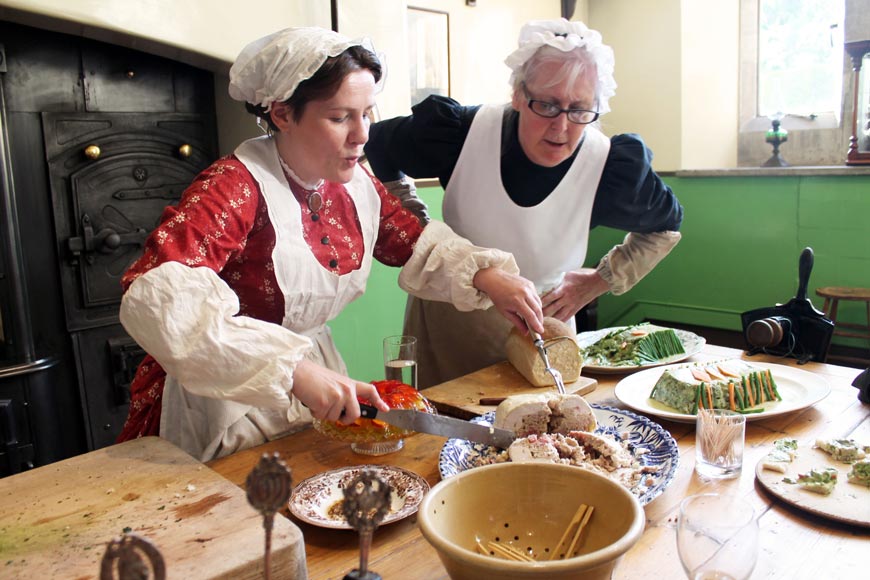 Annie Gray and Dena Saunderson prepare food in the Victorian Kitchen