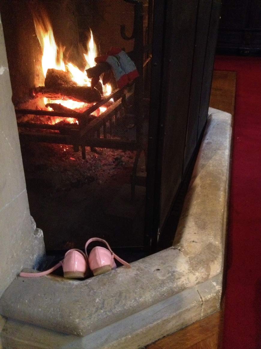 Pink shoes drying in front of Palace House fireplace