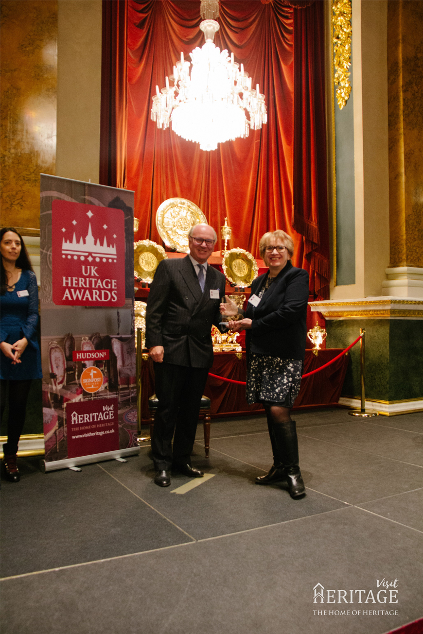 Judith Maddox recieves trophy from judging panel chairman Norman Hudson OBE