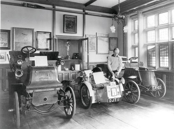 Edward, Lord Montagu and veteran cars in the entrance hall of Palace House