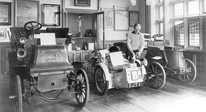 Edward, Lord Montagu and veteran cars in the entrance hall of Palace House