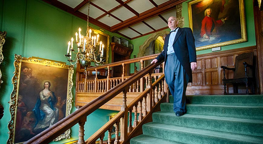 Butler on staircase in Palace House
